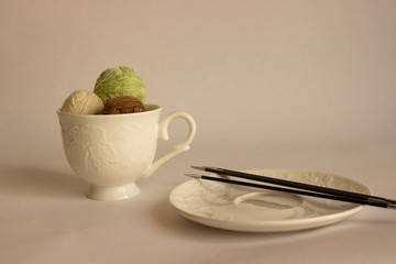 Wool yarn in a coffee Cup