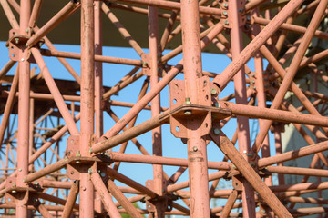 Fototapeta premium Scaffolding Elements Construction. Metal scaffolding tubes and bars. Construction site details. Bridge support. Industrial background.
