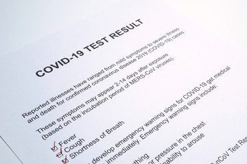 Positive test result for COVID-19 or novel coronavirus pandemic. Stethoscope and novel coronavirus test result on doctor's table