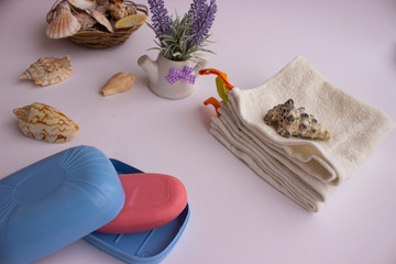 pink hand soap, towels next to it