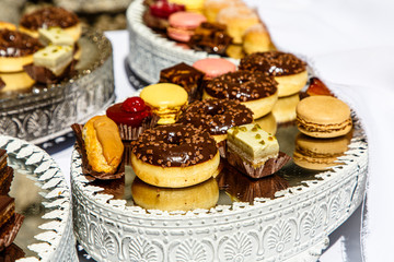 Donuts cakes are on a mirror dish. Furshet