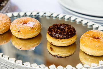 Obraz na płótnie Canvas Donuts cakes are on a mirror dish. Furshet