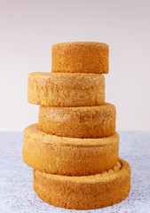 Prepare wedding cake from different sizes sponge cakes.