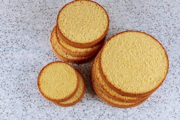 Sliced soft cake on table for making wedding cake.