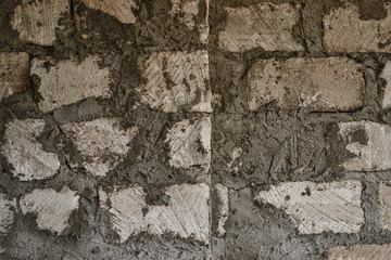 Repair and construction. The old wall. Wall of brick, stone and concrete. Stone and cement background