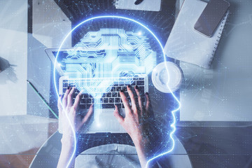 Double exposure of woman working on computer andhuman brain hologram drawing. Top View. Ai concept.