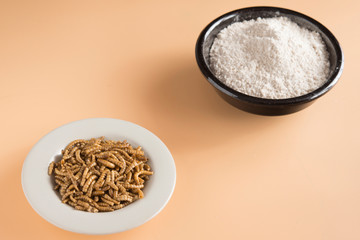 Worm meal flour in brown background