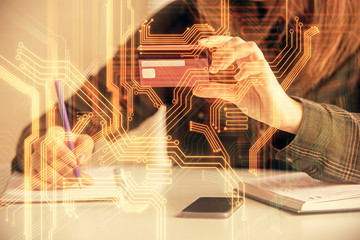 Multi exposure of woman on-line shopping holding a credit card and tech theme drawing. Technology concept.