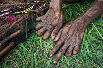 Baliem Valley, West Papua, Indonesia- Older women from the Dani tribe often cut their fingers when...