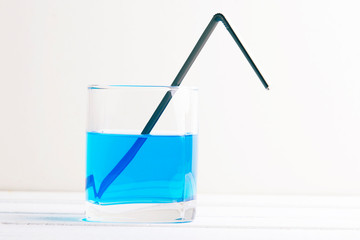 blue drink in a glass, white table