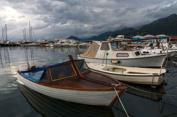Fototapeta na wymiar boats in harbor, stormy weather