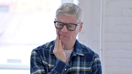 Portrait of Casual Middle Aged Man having Toothache