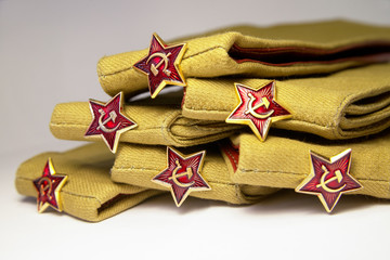 Stack of military caps of the Soviet army with red stars. Garrison cap with a red stars. Red stars...