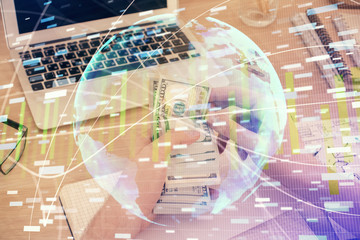 Multi exposure of financial theme drawing hologram and USA dollars bills and man hands. Business concept.