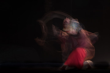 photo of dancer who is blurred by the dance moves