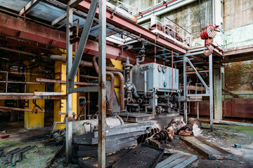 Old rusty Industrial tanks connected by pipes connected with valves in abandoned chemical factory