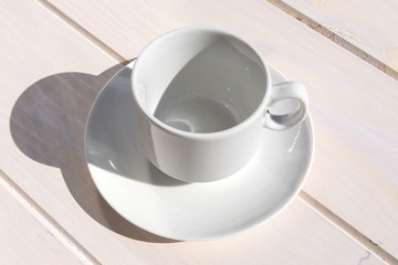 Empty small cup for coffee and saucer