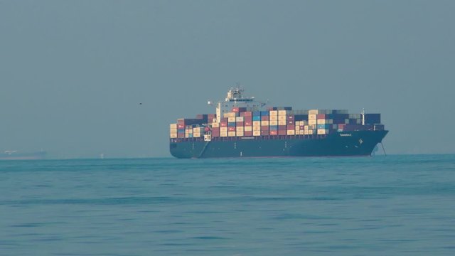 Long shot of container cargo ships in the sea of Hormuz strait in Persian Gulf Iran
