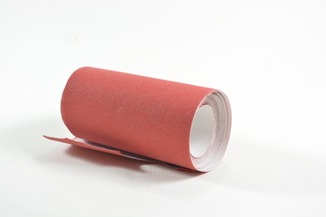 roll of red  sand paper isolated on white