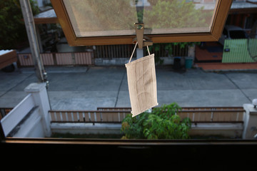 Hygienic mask hanging sunbathing at window after the used and washing,Hang mask on window getting UV from sunshine to kill virus and bacteria