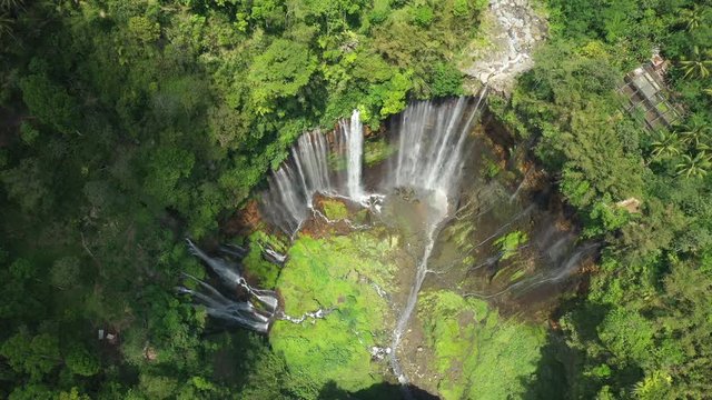 View from above, stunning aerial view of the Tumpak Sewu Waterfalls also known as Coban Sewu. Tumpak Sewu Waterfalls are a tourist attraction in East Java, Indonesia.