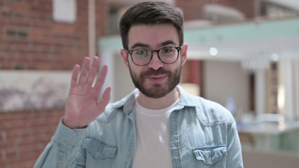 Cheerful Young Man in Glasses doing Video Chat