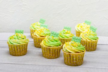 Delicious  christmas cupcakes  with green and yellow cream.