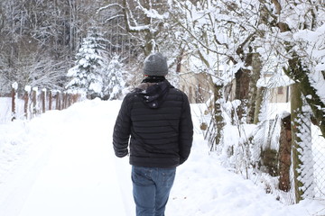 Fototapeta na wymiar man walking in winter forest