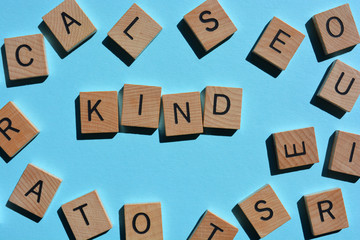 Kind, word surrounded by random alphabet letters on blue