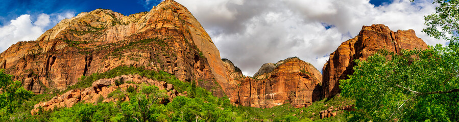 Panoramic view of mountains towering over the Emerald Pool Trail along the Virgin River in Zion National Park.