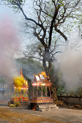 Thai traditional cremating ritual with colored fireworks in countryside at  cemetery.