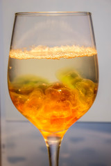 Unusual bright cocktail. Cocktail in a glass. The sun in the glass. Fire cocktail. Background.