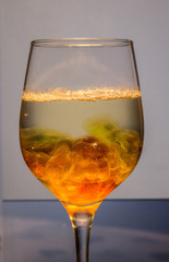 Unusual bright cocktail. Cocktail in a glass. The sun in the glass. Fire cocktail. Background.