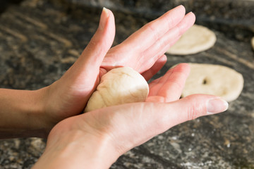 woman hands kneading homemade bread
