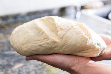 woman hands kneading homemade bread