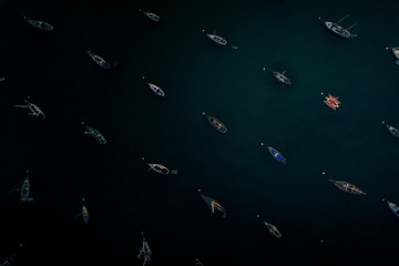 harbor or a bay with a lot of boats and one red boat anchored or moored