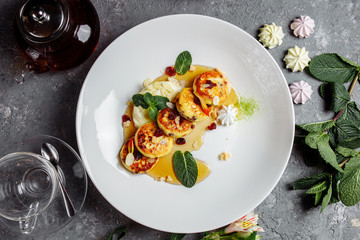 Cheesecake, fresh jam and mint. Cottage cheese pancakes or curd fritters decorated powdered sugar in plate close view. Healthy and diet breakfast.