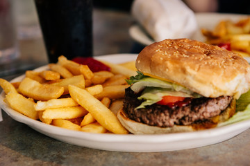 Delicious American burger with fries cooked in a fast food restaurant