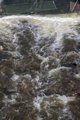 The water flows violently with a fish trap.