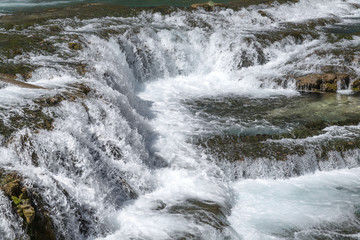 Small waterfall with clear turquoise water in Huancaya town, Lima Region, Peru