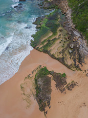 Top down view of mossy rocks on the coastline.