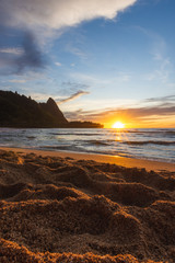 Beautiful Sunset at a Beach in Hawaii with Mountains and Vibrant Colourful Sky