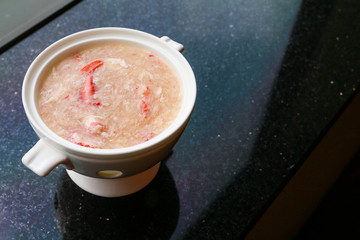 Crab meat soup on a white porcelain bowl.