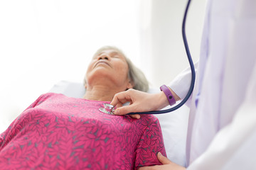 female doctor use stethoscope listening and screening old asian patient, elderly health check up ,...