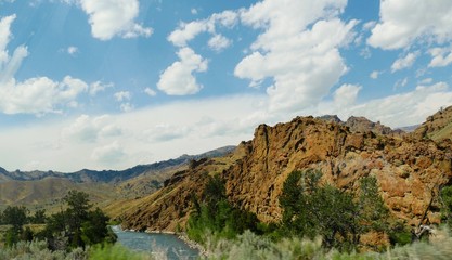 Panoramic view of jagged hills and mountains with the Shoshone River in Wyoming.