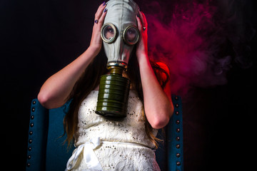 social distancing girl wearing gas mask surrounded by smoke virus in a fashion setting