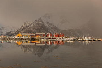 Beautiful landscape with clouds, fog, water, reflectaion in background at Lofoten Island, Norway