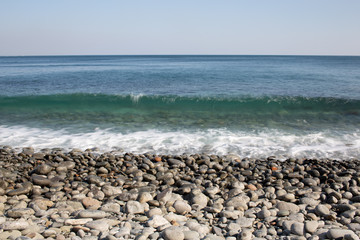 Fototapeta na wymiar round stone seashore, far horizon