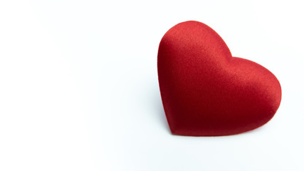 Fototapeta premium Romantic red heart on white background. Copy space at left with heart on right.