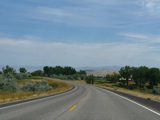 Winding road with scenic nature views in Wyoming, wide shot.
